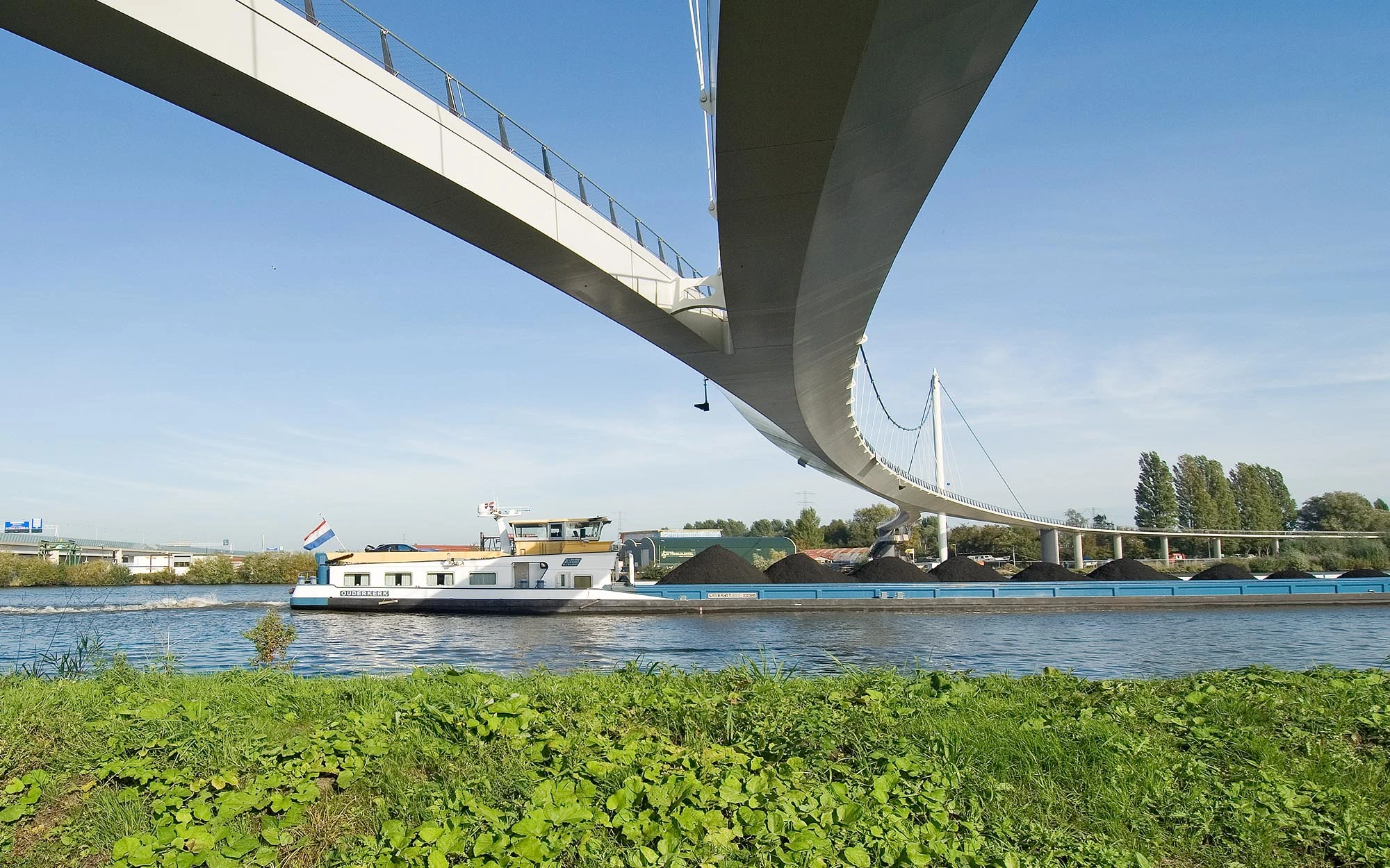 Bridge view from ground with ship passing under